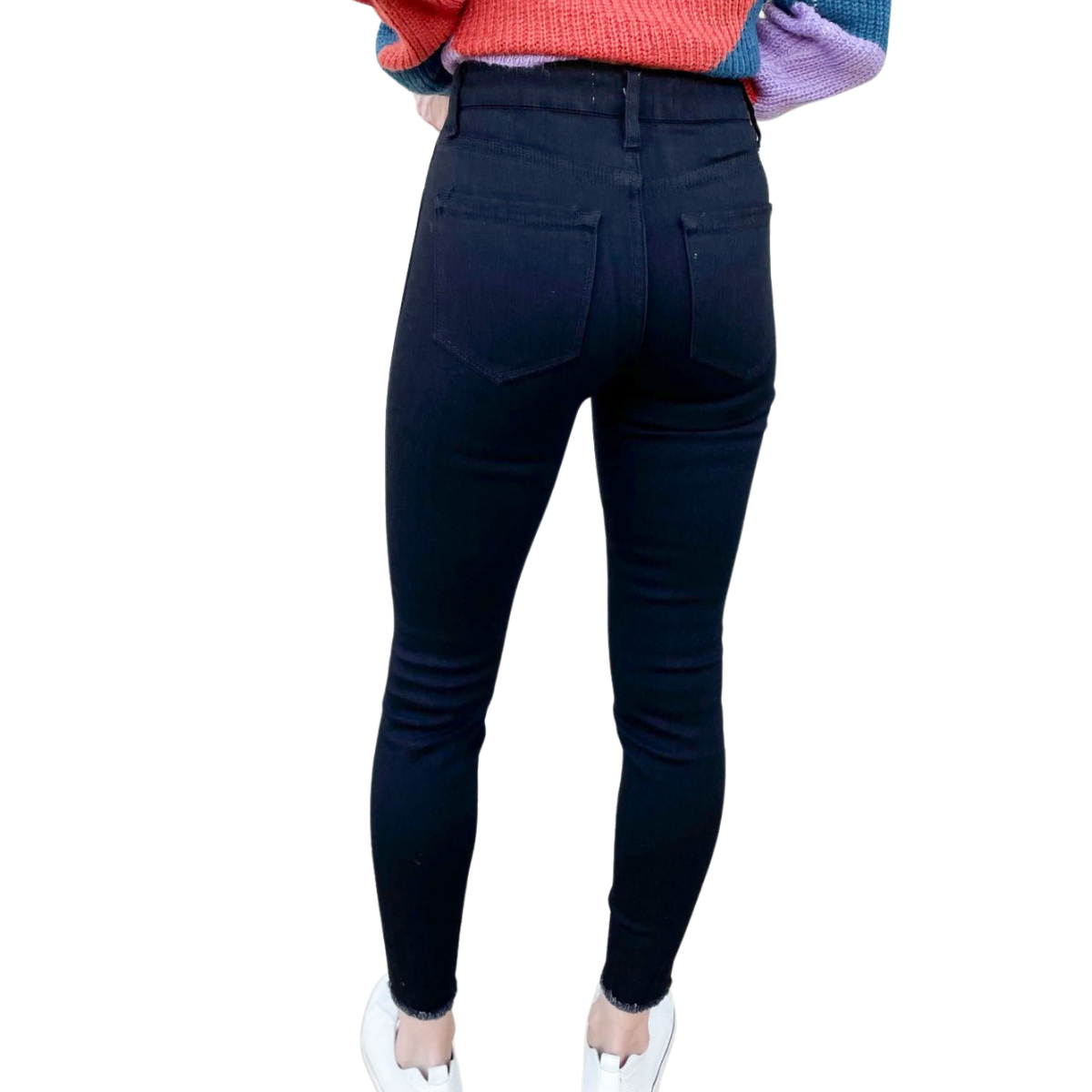 black high-rise skinny jeans with raw hem — back view